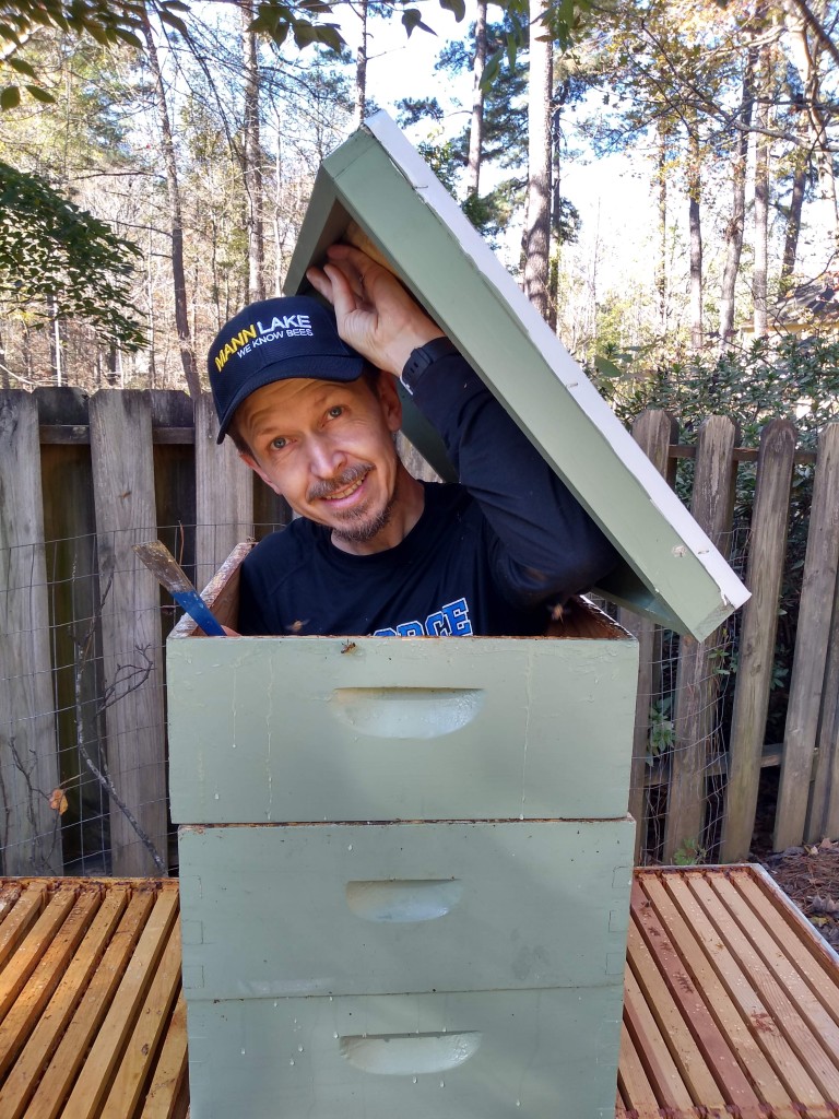 Jim the Bee Man emerging from a beehive