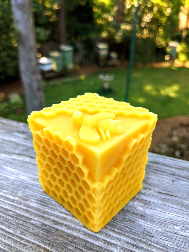 Square honey bee on honeycomb candle